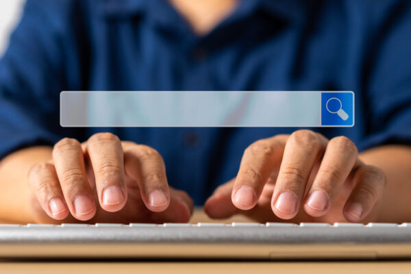 Woman using a phone to search her name online for public records